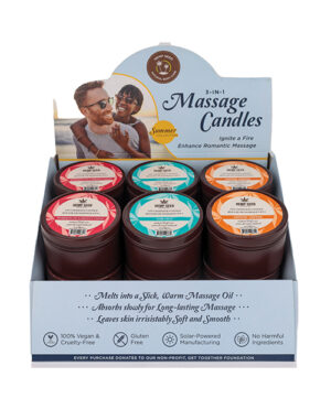A display box containing various 3-in-1 massage candles labeled with different fragrances such as "Red Hot", "Cooling Mint", and "Citrus Boost", featuring a promotional header with an image of a couple enjoying a massage and text highlighting the product benefits. Additional details include the products being vegan, gluten-free, solar-powered manufactured, and free of harmful ingredients with donations made to a non-profit foundation with each purchase.
