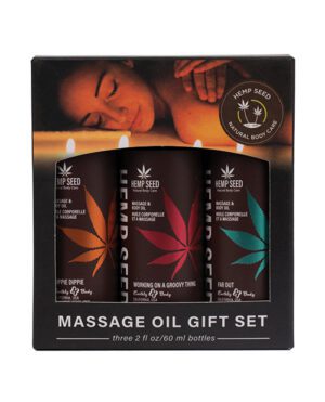 A massage oil gift set box with three bottles, each labeled with different colored hemp leaf graphics and names "Guavalava," "Skinny Dip," and "Naked in the Woods." The box has an image of a relaxed person receiving a shoulder massage and the logo "HEMP SEED NATURAL BODY CARE."