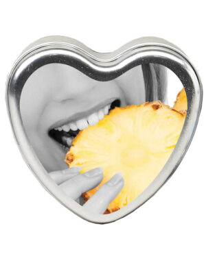 A monochrome image featuring a person's mouth, holding a slice of pineapple, framed within a heart-shaped tin.