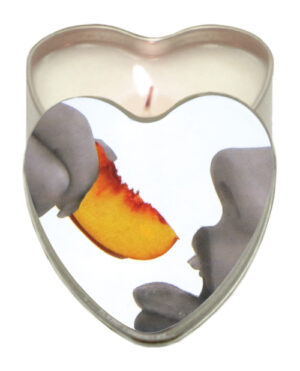 Scented Romance::A heart-shaped candle with a whimsical design featuring a hand holding a peach slice, symbolizing love and sweetness.