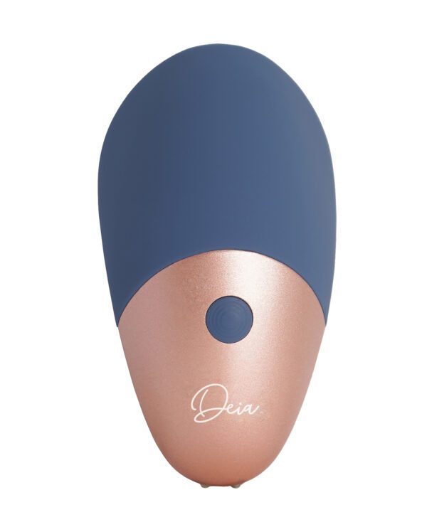 A navy and rose gold handheld beauty device with a single button and branded "Deia".