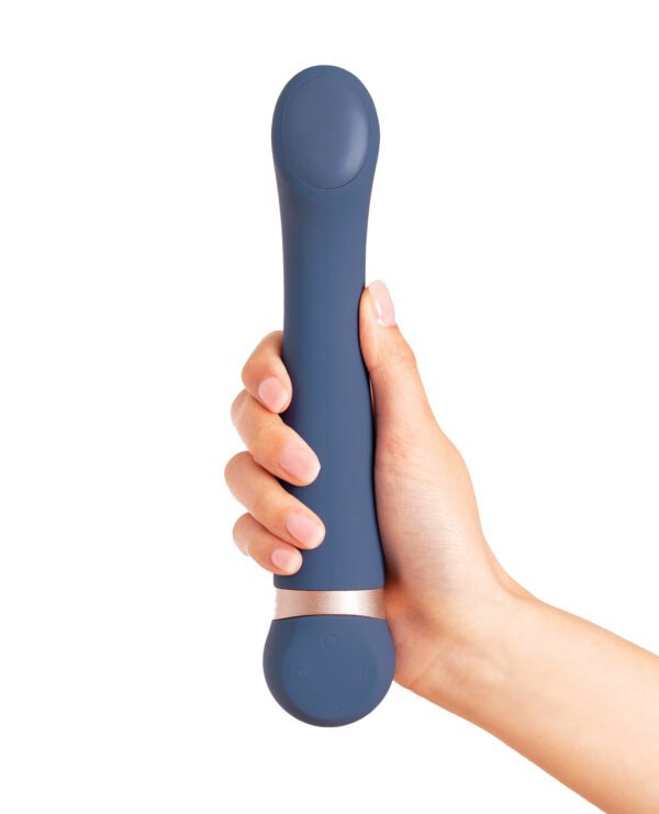 A hand holding a blue personal massage device with control buttons, isolated on a white background.