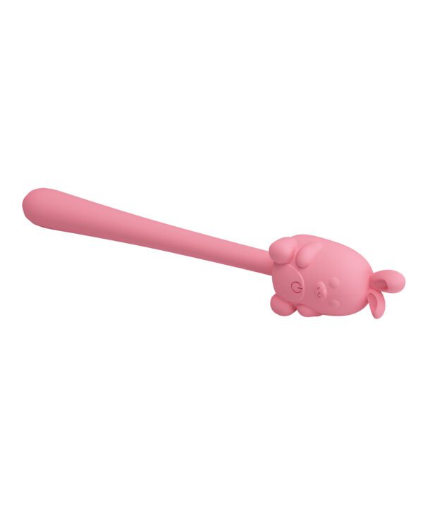 A pink spoon with a cartoon cat figure on the handle against a white background.