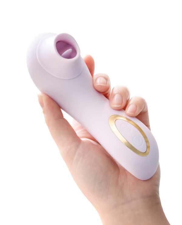 A person holding a lavender handheld massager with a gold accent and control buttons, set against a white background.