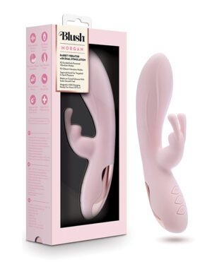 The image shows a pink rabbit vibrator named "Blush Morgan" that provides dual stimulation, displayed next to its packaging. The packaging highlights the product features, which include 10 vibrating functions, dual motors, and a body-safe material. The toy and package have a soft pink color scheme.
