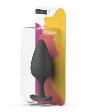 Bswish Plug Packaging::A sleek black anal plug displayed in clear packaging with colorful abstract design in the background.