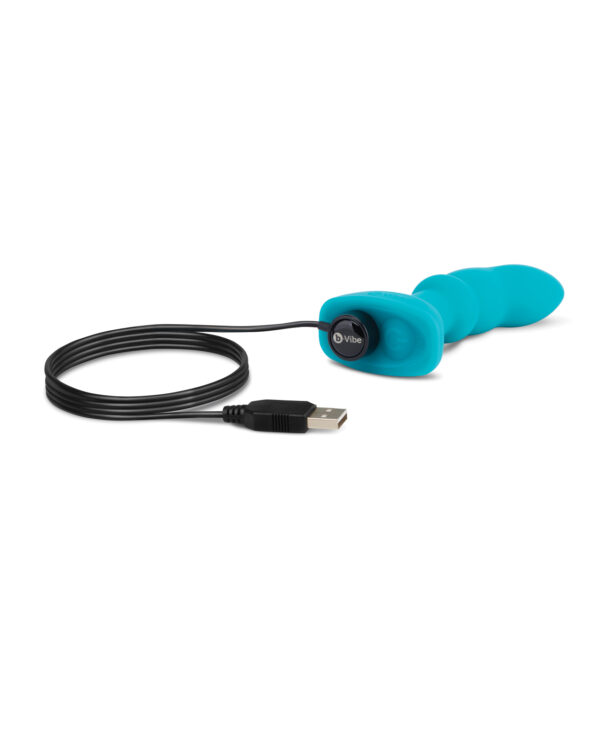 A vibrant blue pleasure device connected to a black USB charging cable.