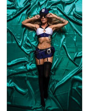 A model poses in a police-inspired costume on a green satin background