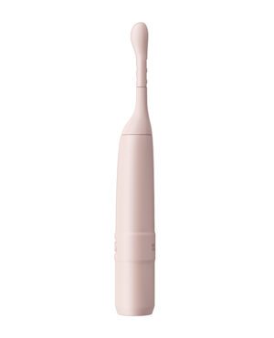 A pink handheld electric facial cleansing brush isolated on a white background