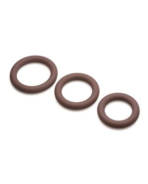 Three chocolate rings of varying sizes arranged diagonally on a light background.