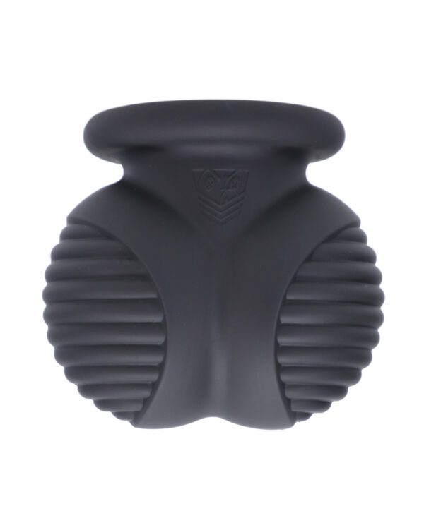 Close-up view of a black silicone facial cleansing brush with textured surfaces.