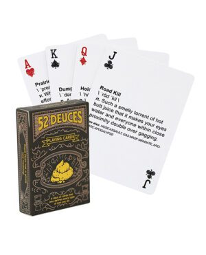 A deck of 52 Deuces playing cards with humorous text on face cards, displayed fanned out with the box visible.