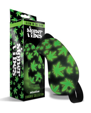 A pair of glow-in-the-dark slippers with cannabis leaf patterns, displayed next to their packaging which reads "Stoner Vibes" and "Chronic Collection."