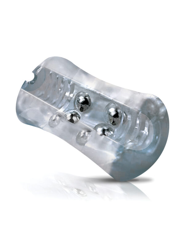 A clear dental retainer with metal springs on a reflective surface.