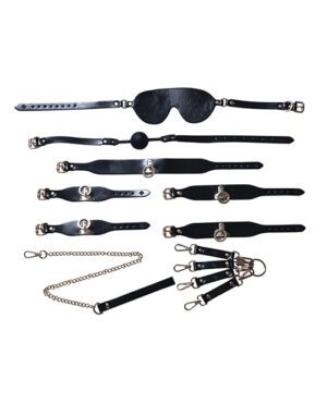 A set of black leather BDSM accessories laid out on a white background, including a blindfold, various straps with buckles, a ball gag, a pair of handcuffs connected by a chain, and two types of collars with metal rings.