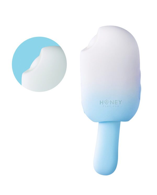 Image of a blue silicone object designed to resemble an ice cream bar with a circular magnification on the top left showing a close-up texture, including the brand name HONEY PLAY BOX on the handle.