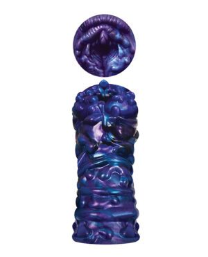 Alt text: A glossy, textured sculpture with iridescent purple and blue colors resembling abstract organic forms, topped by a circular element with a pattern similar to a mouth.