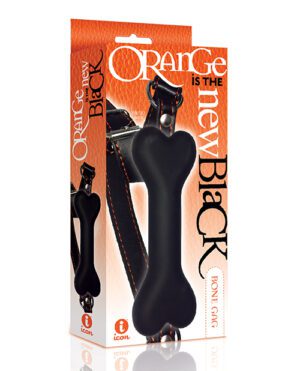 Product packaging for a black dog chew toy with the slogan "Orange is the new Black" printed on it, against an orange background.