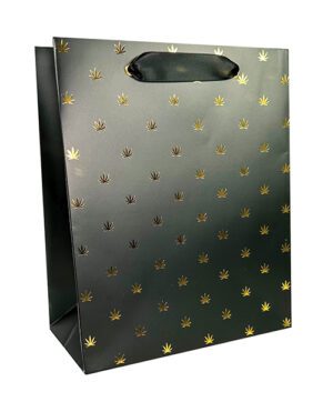 A black paper gift bag with a gold leaf pattern and an oval handle.