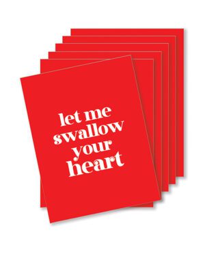 Stack of red postcards with the phrase "let me swallow your heart" written in white text.