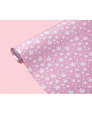 A roll of pink wallpaper with a white floral pattern on a pink background.