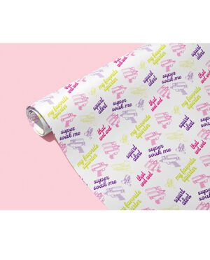 Roll of wrapping paper with colorful water gun prints and 'super soak me' text on a pink background.