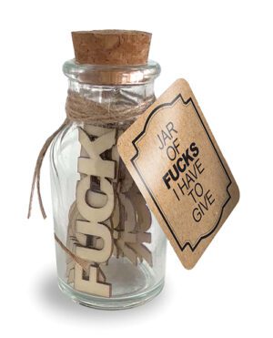 A glass jar with a cork stopper tied with twine and filled with cutouts of the word "F*CK." Attached to the jar is a label with the text "JAR OF F*CKS I HAVE TO GIVE."