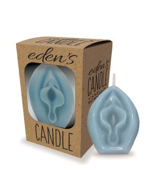 A blue, leaf-shaped candle next to its packaging box with a window displaying the candle inside. The box is labeled with "eden's CANDLE" and "VANILLA" on a brown, eco-friendly background.