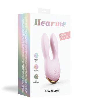 A pink "Hearme" silent stimulator product standing in front of its packaging which has a holographic design and lists features such as "whisper quiet," "beginner," and "USB rechargeable."