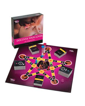 A board game titled "Discover Your Lover" displayed on a table with its box, featuring game cards, tokens, and a game board arranged for play. The game board has a star-shaped path with various colored spaces and card decks placed at strategic points.