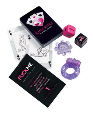 Alt text: A collection of adult-themed items including a deck of Kama Sutra playing cards, two sex position dice, and two silicone rings. The cards and one of the dice feature illustrated figures in various positions, while a card labeled "F*CKME" provides instructions or suggestions for use. All items have a black and purple color scheme.