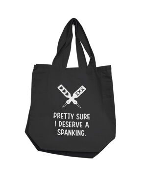 Black tote bag with white text saying "PRETTY SURE I DESERVE A SPANKING" and graphic of crossed paddles with lace patterns.