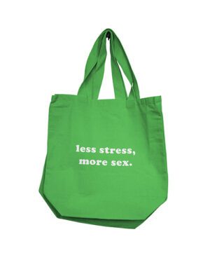 A green tote bag with the phrase "less stress, more sex." printed in white letters.