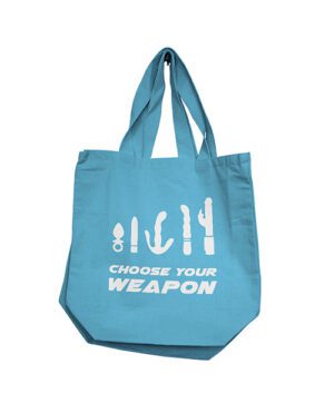 Blue tote bag with the phrase "CHOOSE YOUR WEAPON" and kitchen utensils graphics.