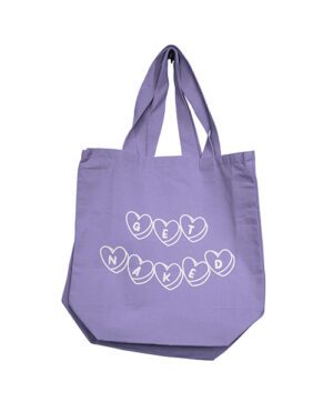 A lavender tote bag with "GET NAKED" printed on it in heart shapes.