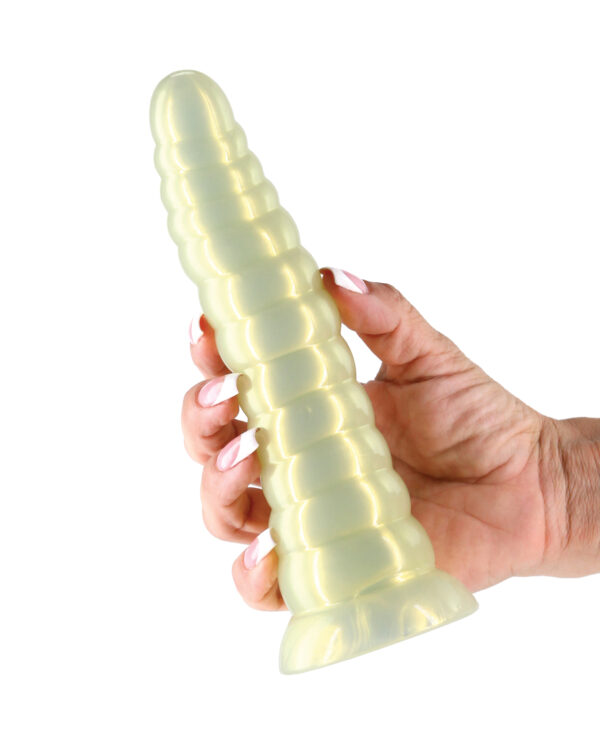 Sensual Silicone Toy:::A hand holding a translucent, spiral-shaped silicone toy in a light yellow color against a white background.