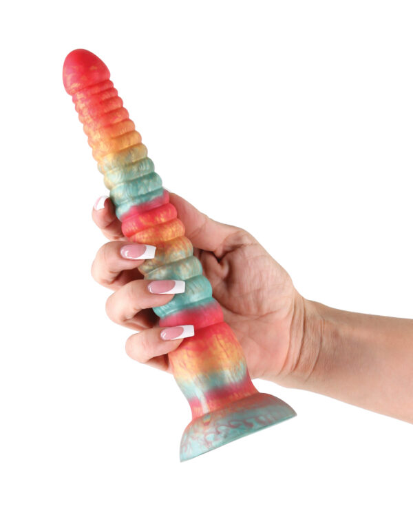 A person holding a vibrant, multi-colored silicone dildo with a textured surface and flared base.