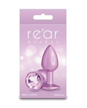 A pink packaging featuring a shiny aluminum plug with a jewel accent, showcasing the product name "re'ar assets" and the brand "nsnovelties."