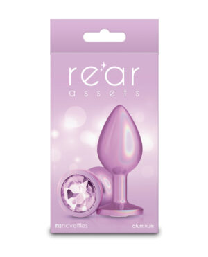 A packaging design showcasing a purple aluminum anal plug with a gem detail, featuring the brand name "rear assets" and the company "nsnovelties."