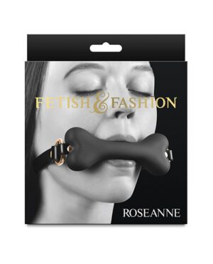 Alt text: Packaging design featuring a close-up of a woman's lower face with a black object in her mouth, labeled with "FETISH & FASHION" and the name "ROSEANNE" at the bottom. The package has a die-cut hole for hanging on a display.