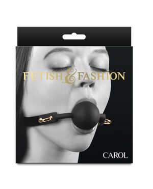 Product packaging featuring the close-up image of a woman's lower face wearing a black ball gag, with the words "FETISH & FASHION" written above and "CAROL" below. The package appears to be designed to hang from a display hook.