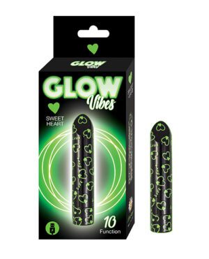 Product packaging for "GLOW Vibes Sweet Heart" featuring a black and green box with a glowing effect around the text and image of a patterned personal massager next to the box, advertising "10 Function".