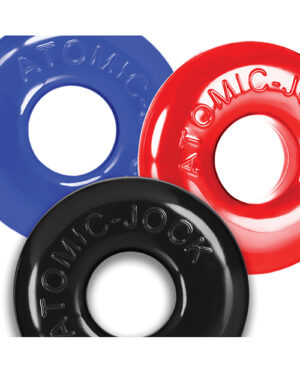 Three circular rubber rings in blue, red, and black, each embossed with "ATOMIC JOCK" text, overlapping slightly and arranged diagonally.