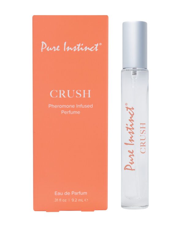 A bottle of Pure Instinct Crush pheromone-infused perfume next to its orange packaging box with product details.