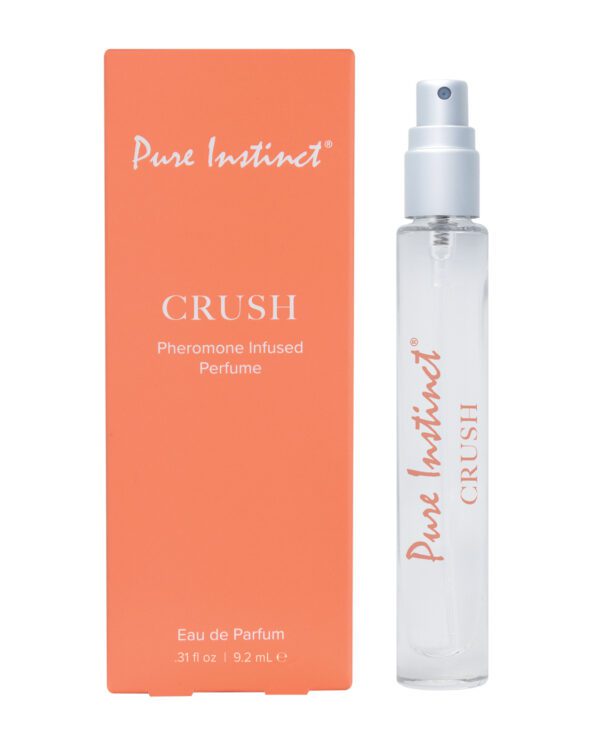 Orange packaging box labeled "Pure Instinct CRUSH Pheromone Infused Perfume" next to a clear bottle with spray nozzle