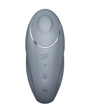 A handheld facial cleansing brush with a round head, power button, and plus/minus intensity controls on a sleek grey body.