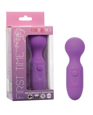 A purple rechargeable massager by CalExotics, labeled "FIRST TIME", is displayed next to its packaging, which indicates a 10-function feature and is designed predominantly in pink and white.