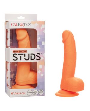 An orange silicone adult toy standing next to its packaging, which includes the brand name "CALEXOTICS" and the product description "NEON SILICONE STUDS".