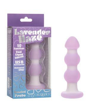 A lavender adult toy next to its packaging which includes the product name "Lavender Haze," a description that says "10 Functions Dual Liquid Silicone USB Rechargeable Waterproof - IPH7," and the brand name "Calexotics."