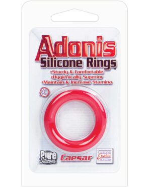 Packaging of 'Adonis Silicone Rings' with a red silicone ring visible in a clear plastic blister, highlighting features like sturdy, comfortable, hygienically superior and claiming to maintain and increase stamina.